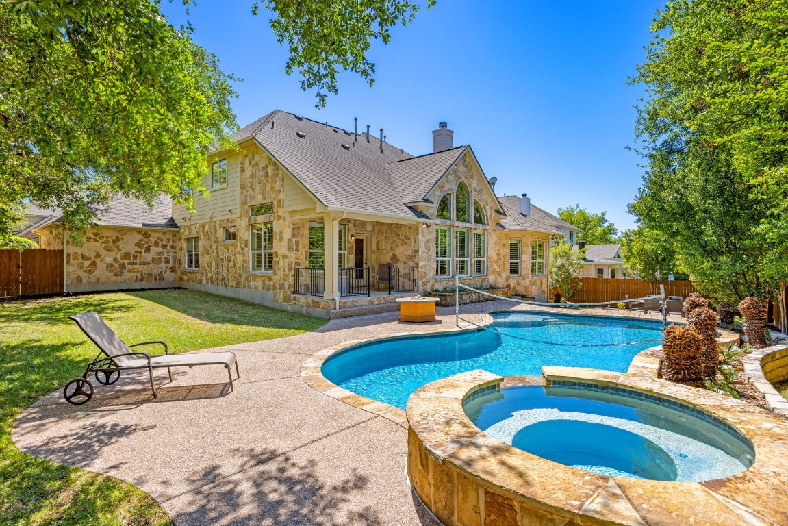 a view of a house with swimming pool and sitting area