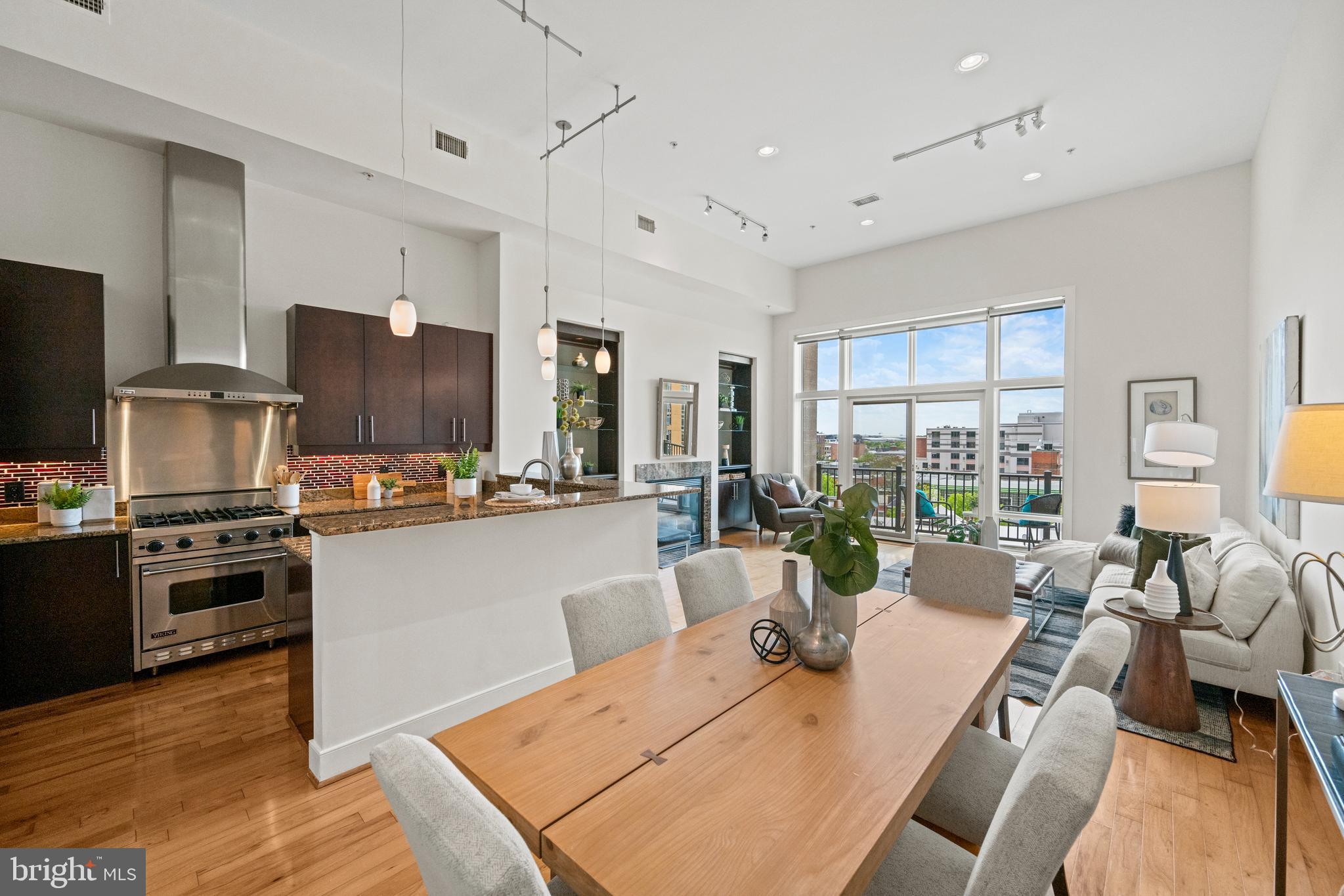 a large kitchen with a table chairs refrigerator and a stove