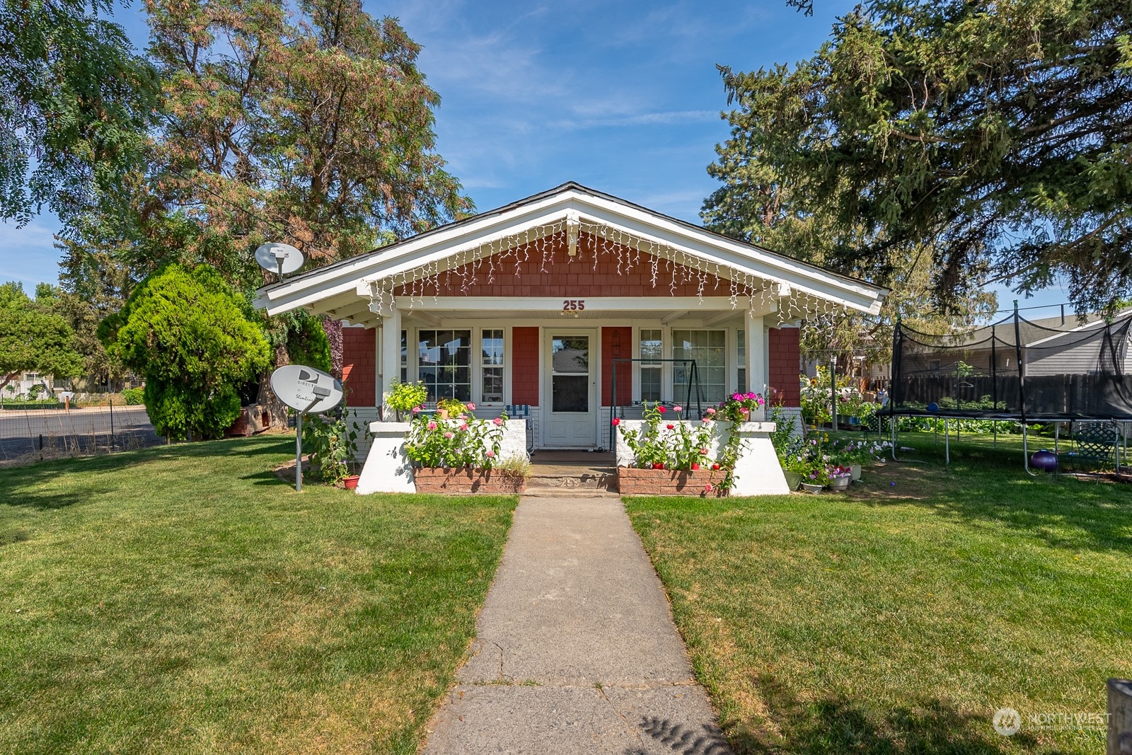 a front view of a house with garden and porch