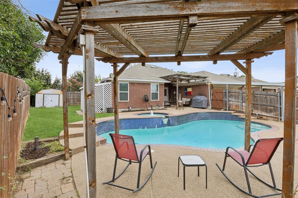 a view of a patio with a table chairs and a backyard