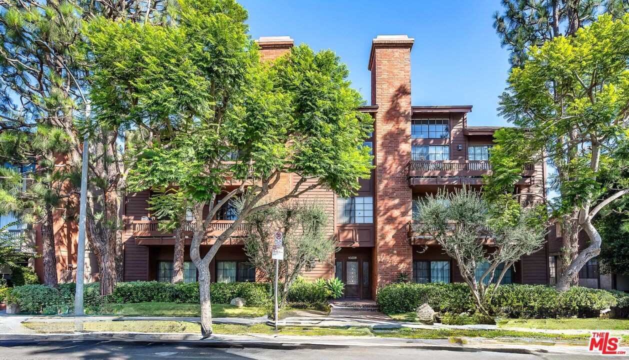 front view of a building with a tree