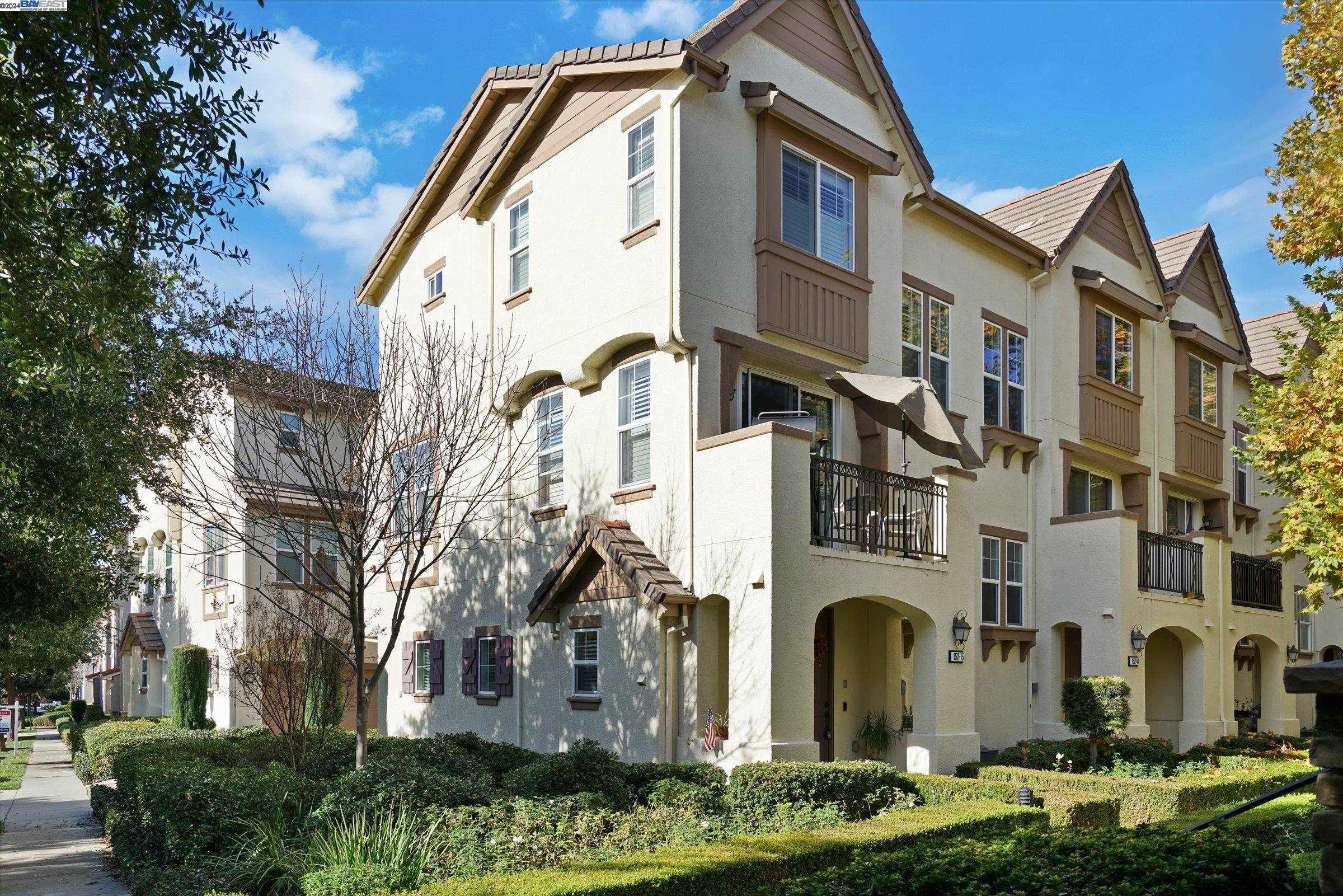 a front view of a residential apartment building with a yard