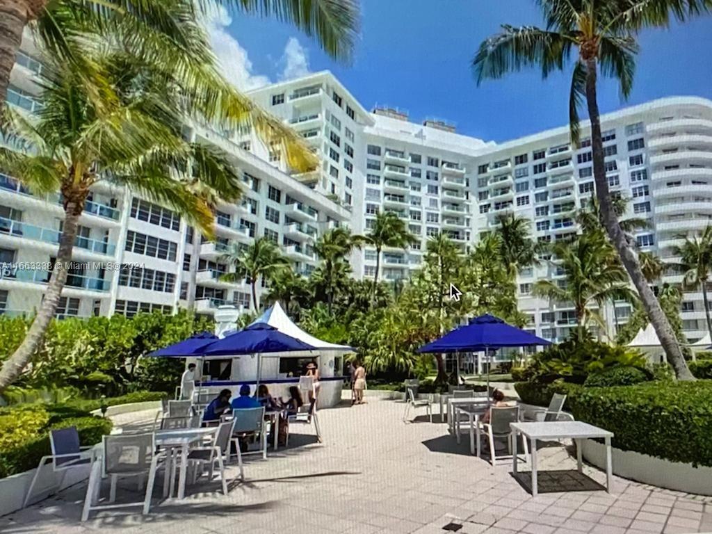 a patio with a table and chairs under an umbrella