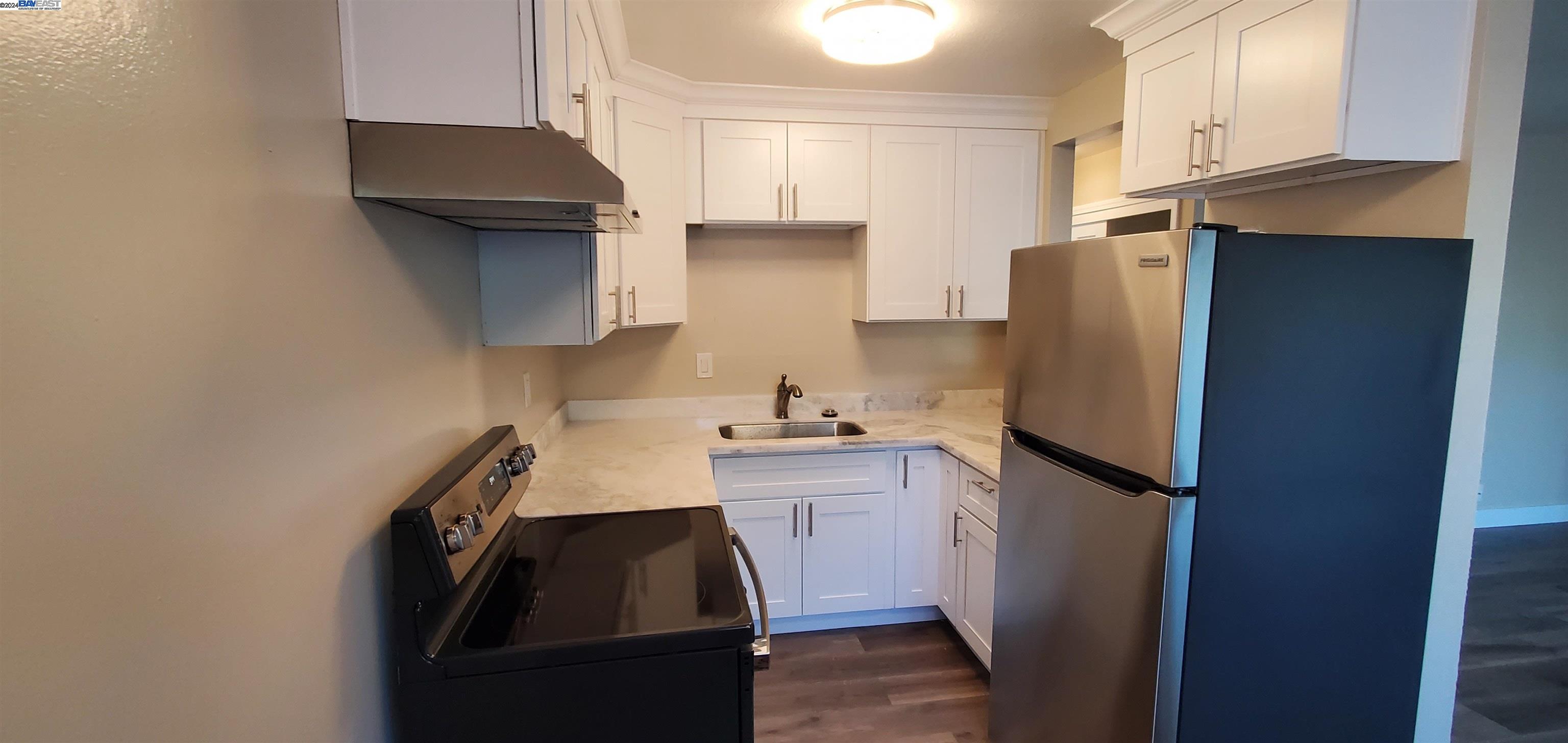 a kitchen with a refrigerator and a sink