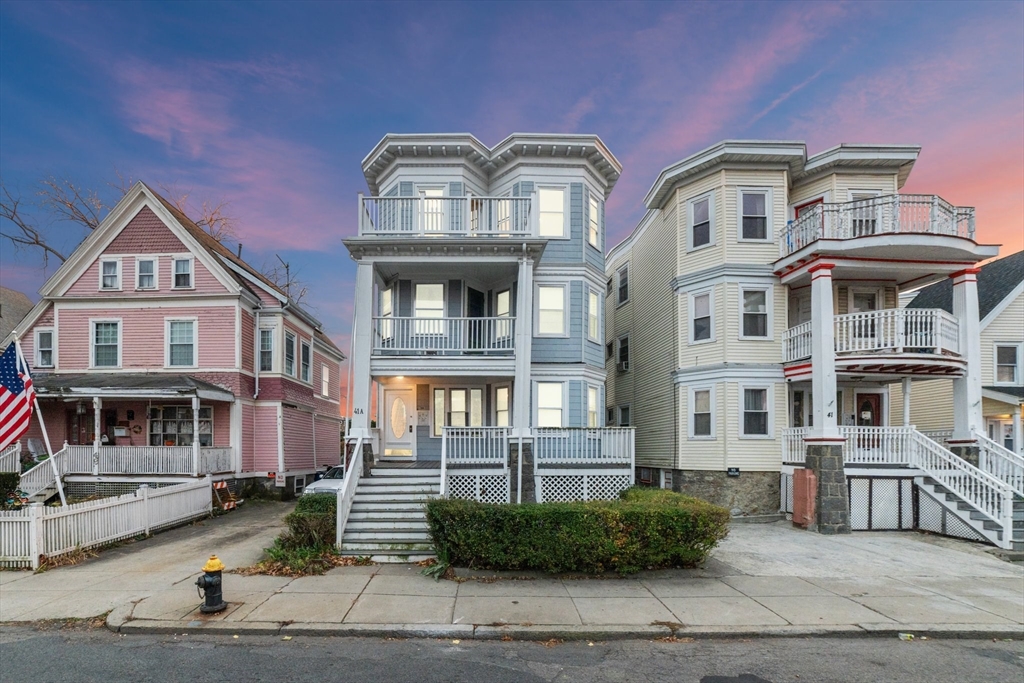 a front view of residential houses with yard