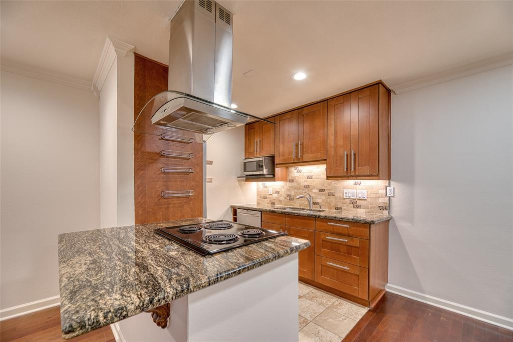 a kitchen with granite countertop a stove and a sink