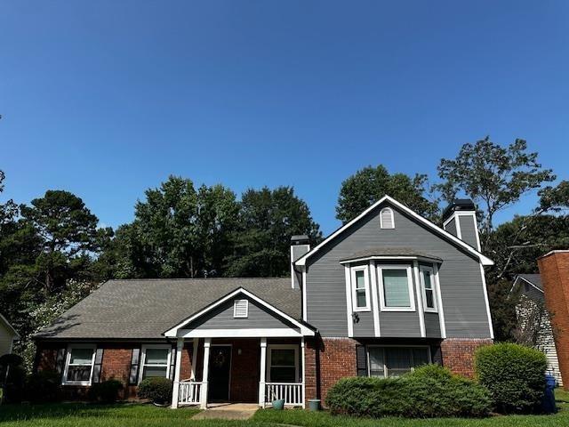 a front view of a house with a yard