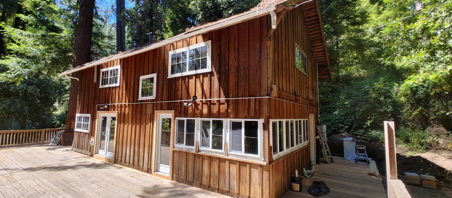 a view of a wooden house with a small yard