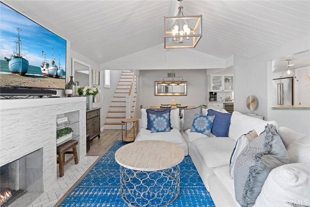 a living room with furniture and a dining table