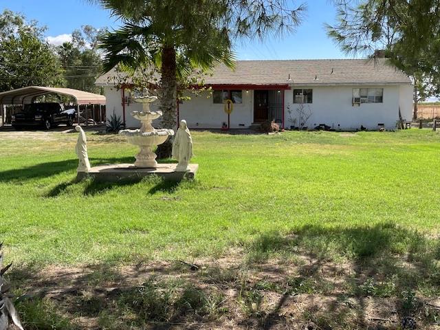 a front view of house with yard and trees