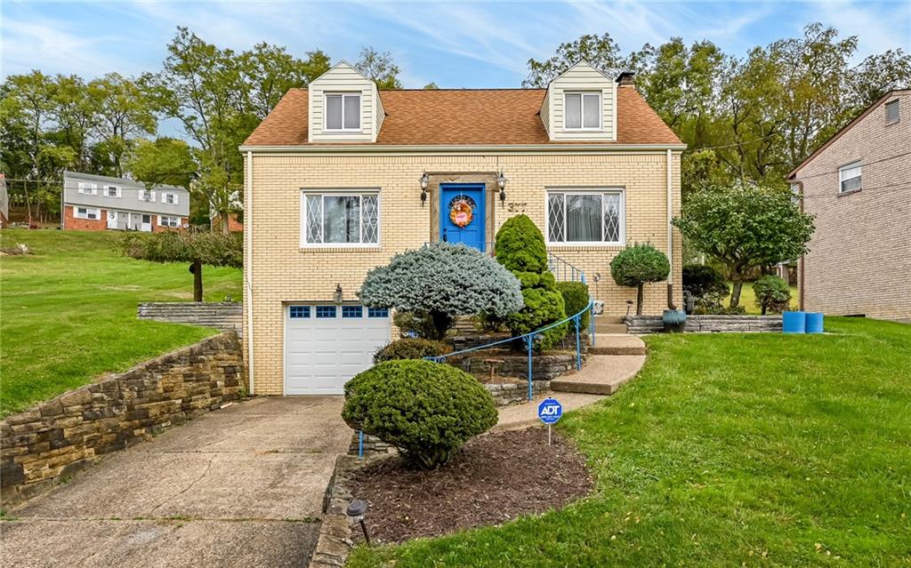 a front view of a house with garden