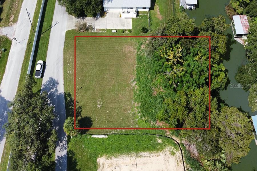 an aerial view of a residential houses with yard