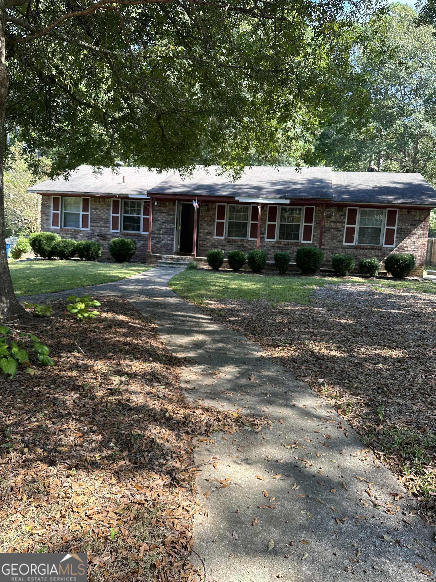 a front view of a house with a garden