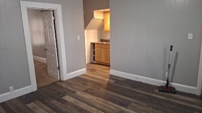 an empty room with wooden floor and a window