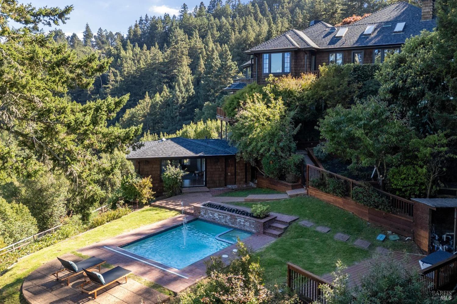 an aerial view of a house with swimming pool garden and patio