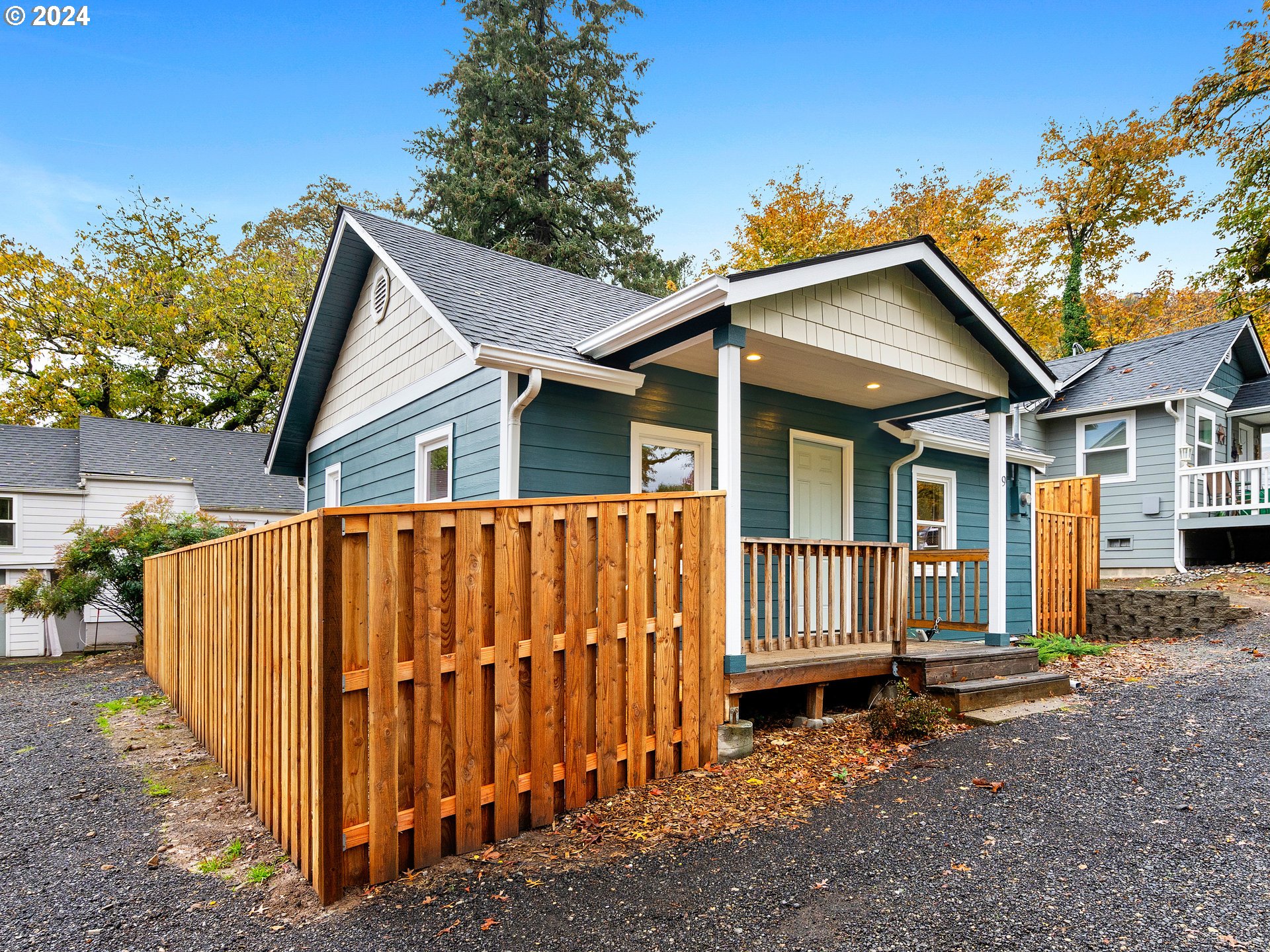 a view of a house with wooden fence