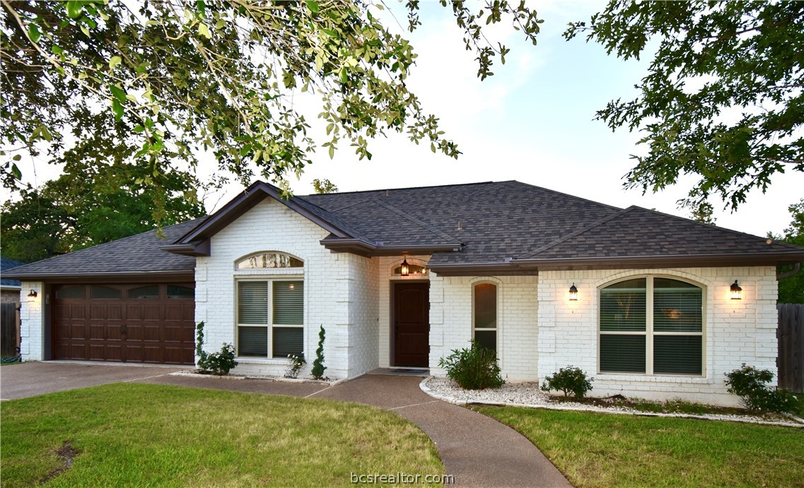 a front view of a house with a yard and porch