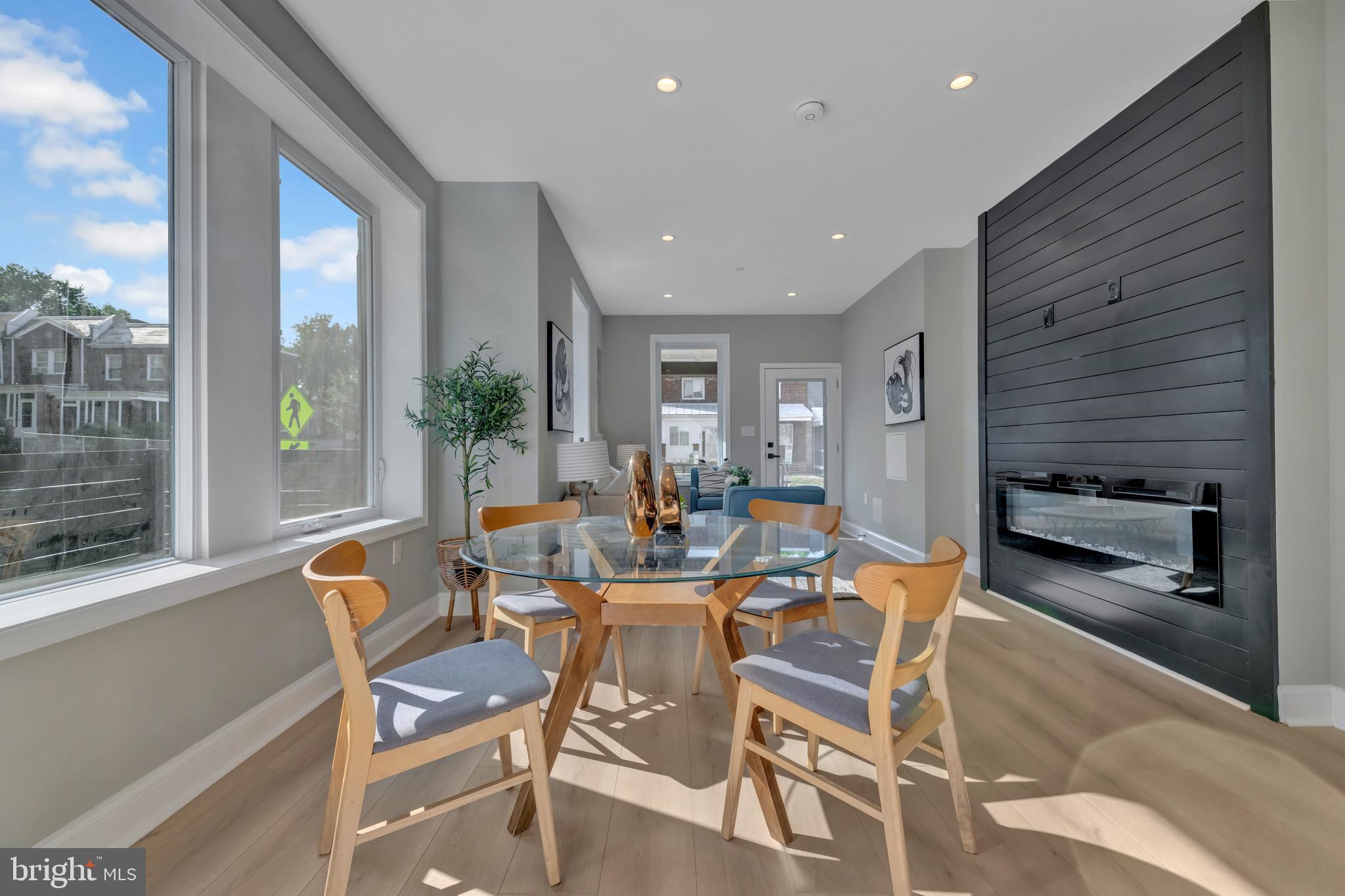 a dining room with furniture and a floor to ceiling window