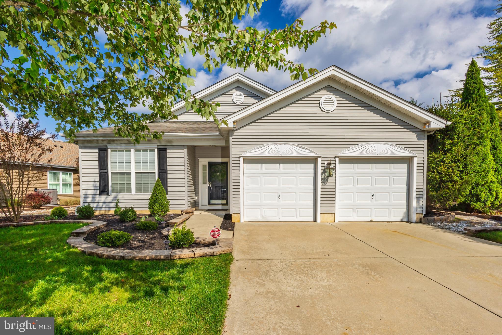 a front view of a house with a yard and outdoor seating