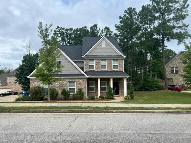 a front view of a house with a yard