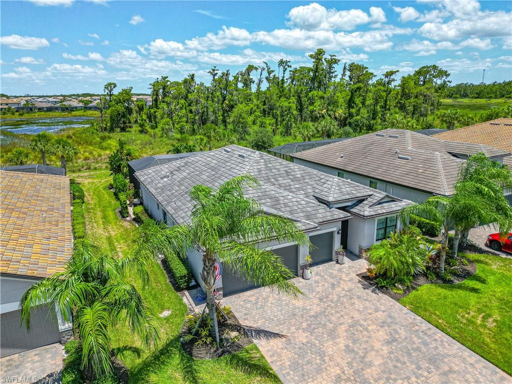 an aerial view of a house with yard and outdoor seating