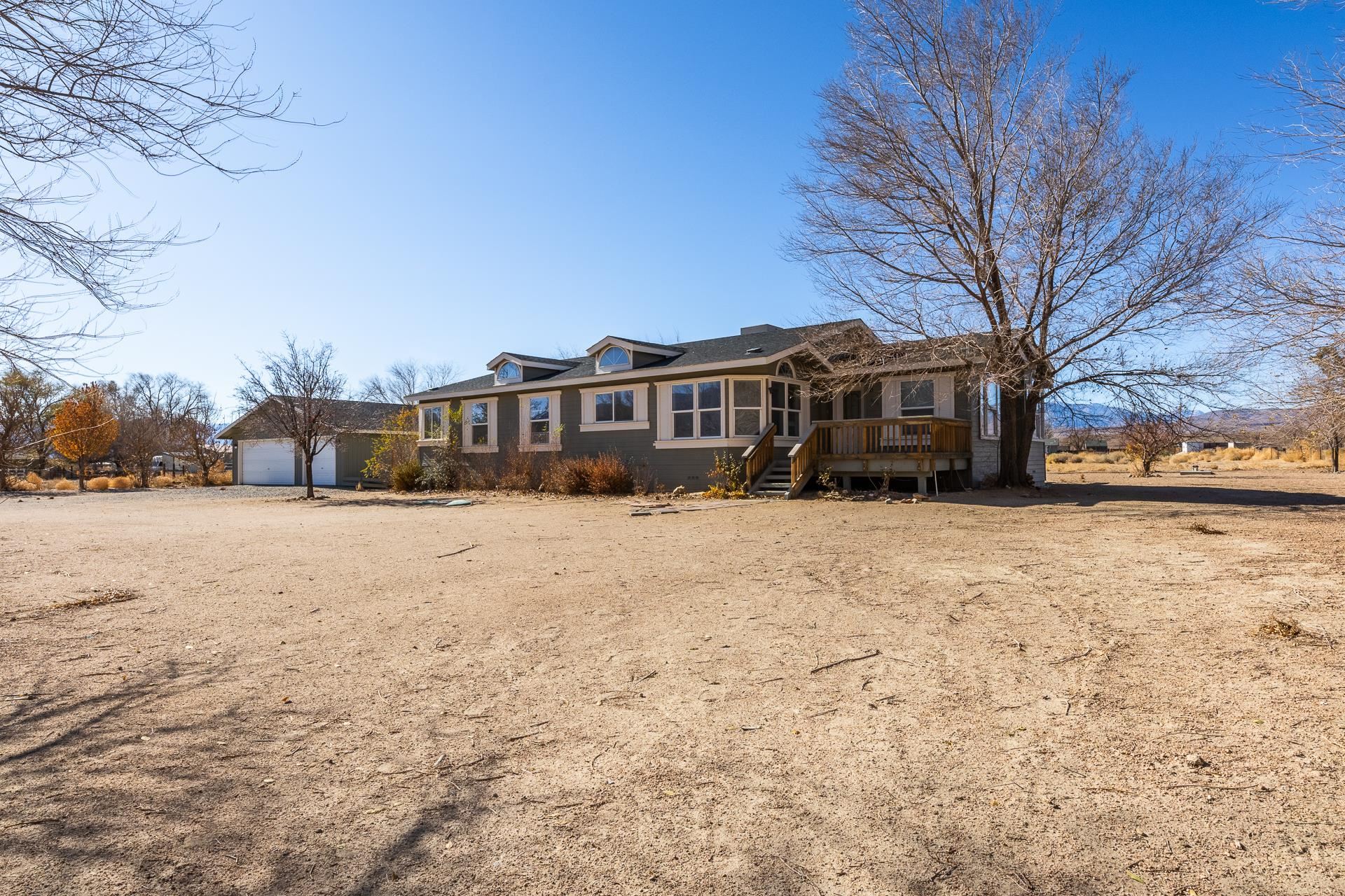 a view of large house with a yard covered in snow