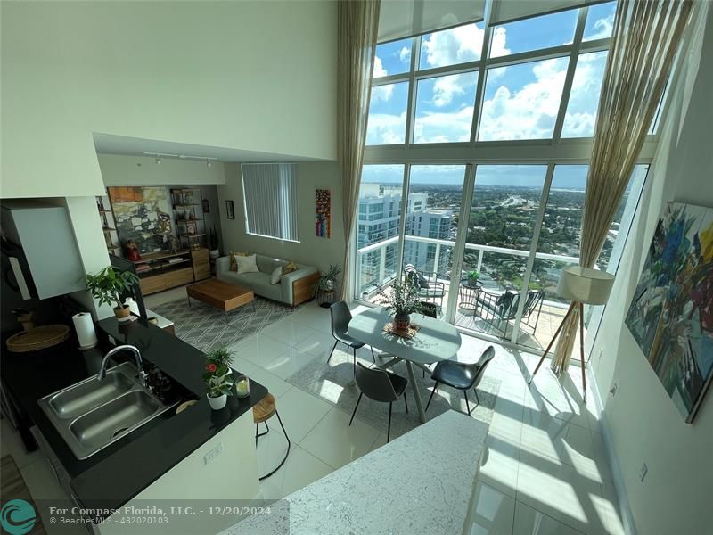 a living room with furniture and a floor to ceiling window