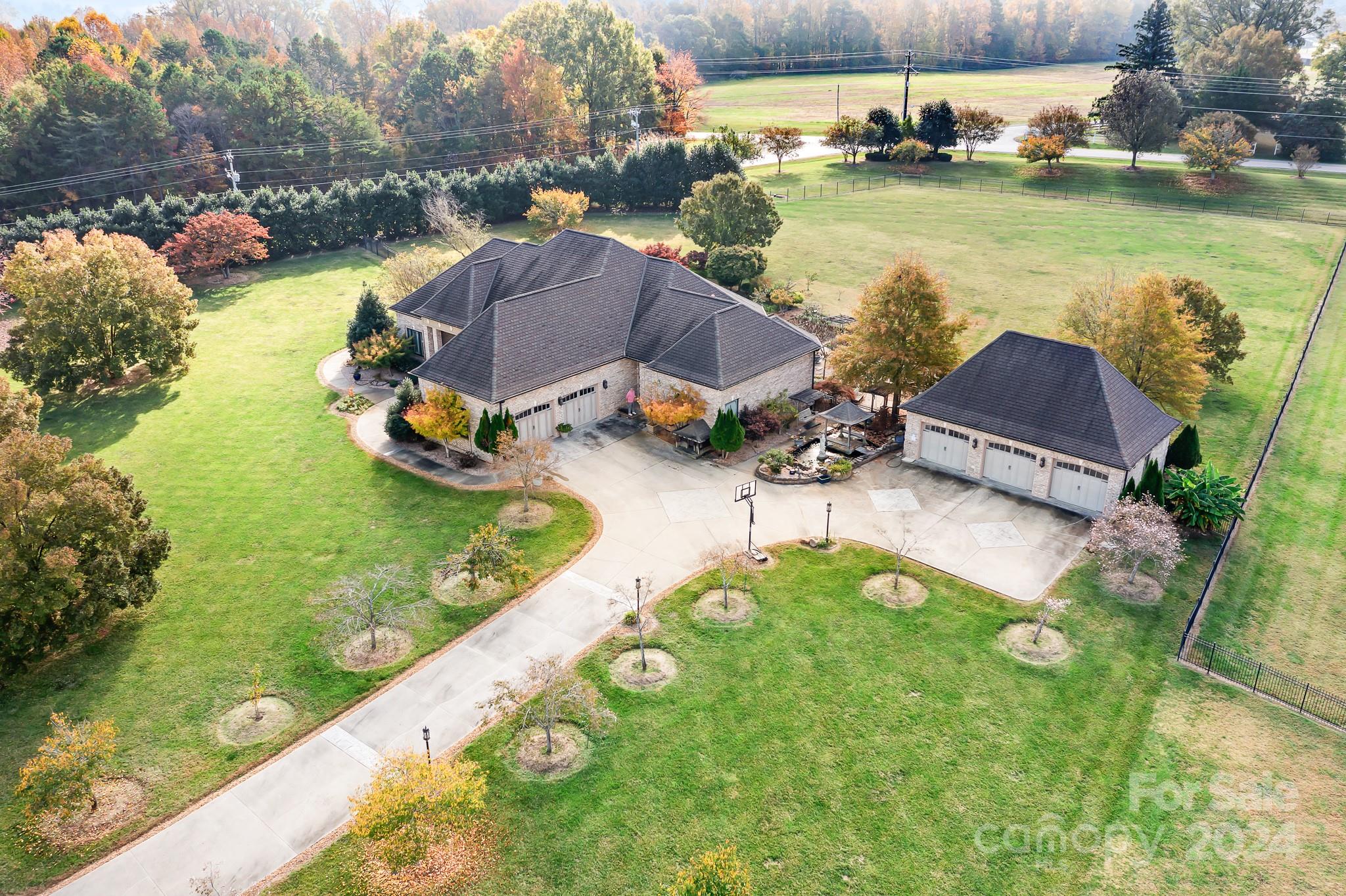 an aerial view of a house with a garden and lake view