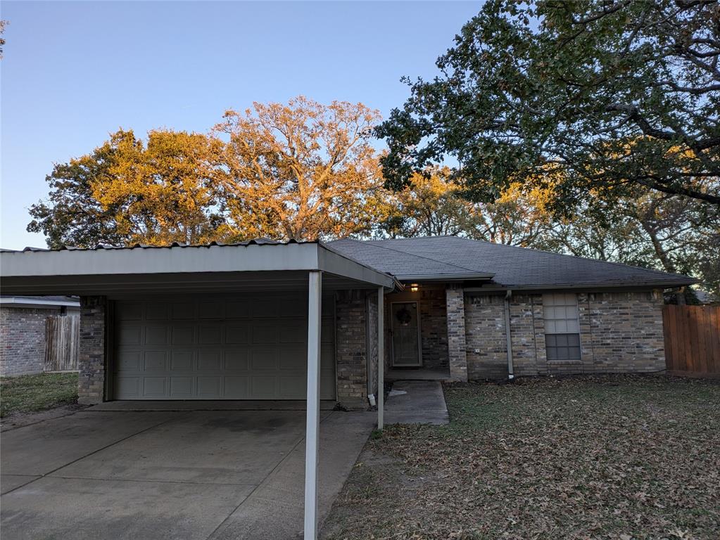 a front view of a house with a tree