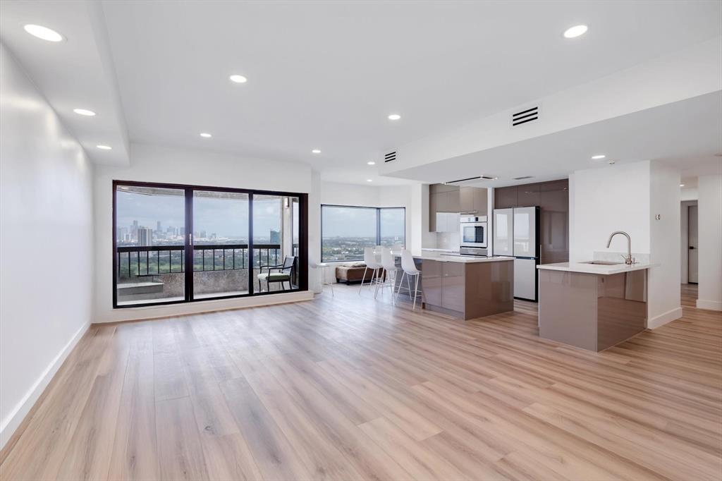 a view of a kitchen with kitchen island wooden floors wooden floor and center island