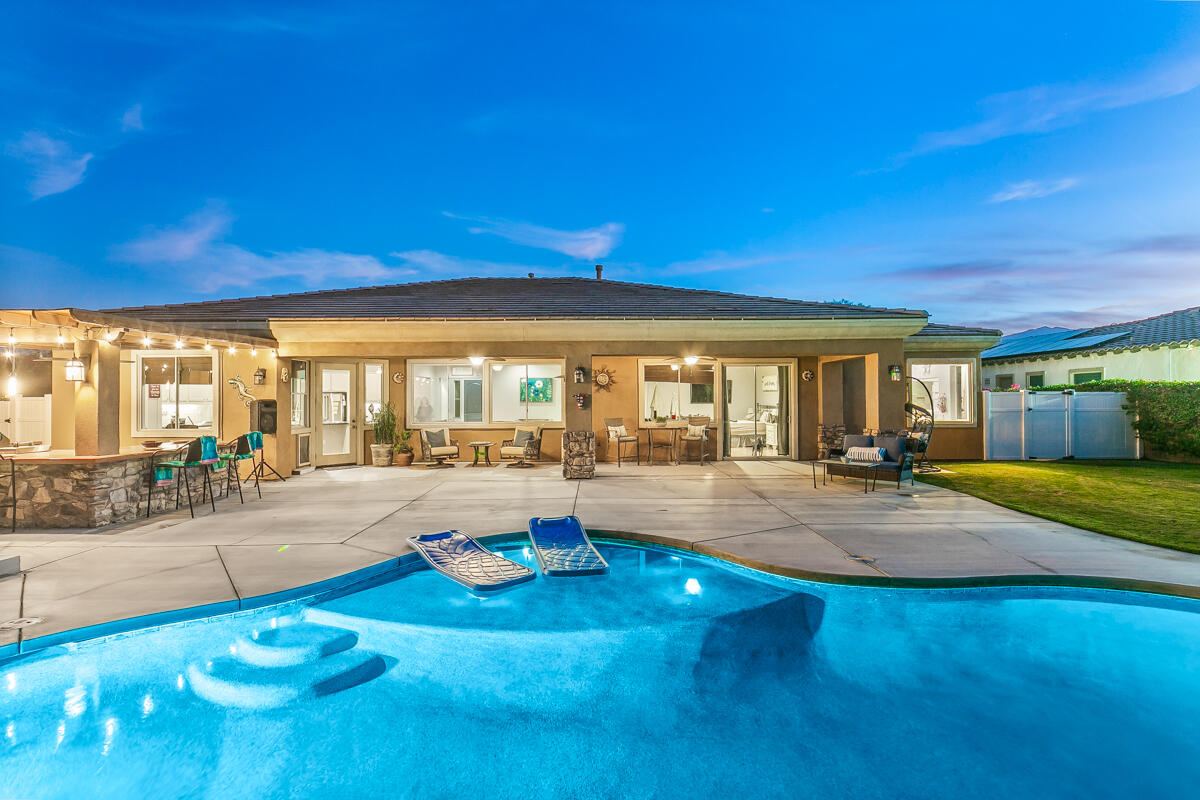 a view of a patio with swimming pool table and chairs