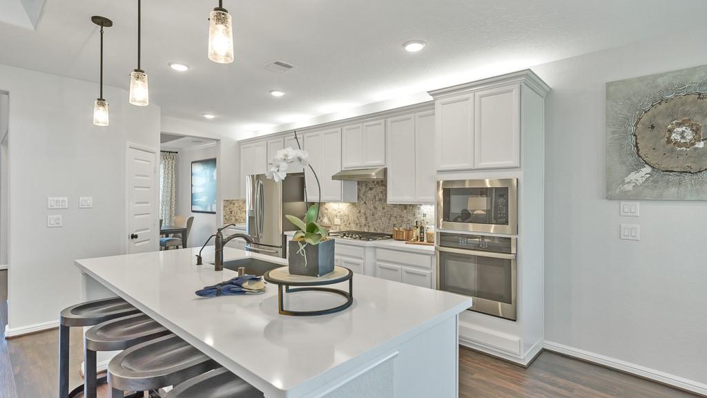 a kitchen with sink and refrigerator