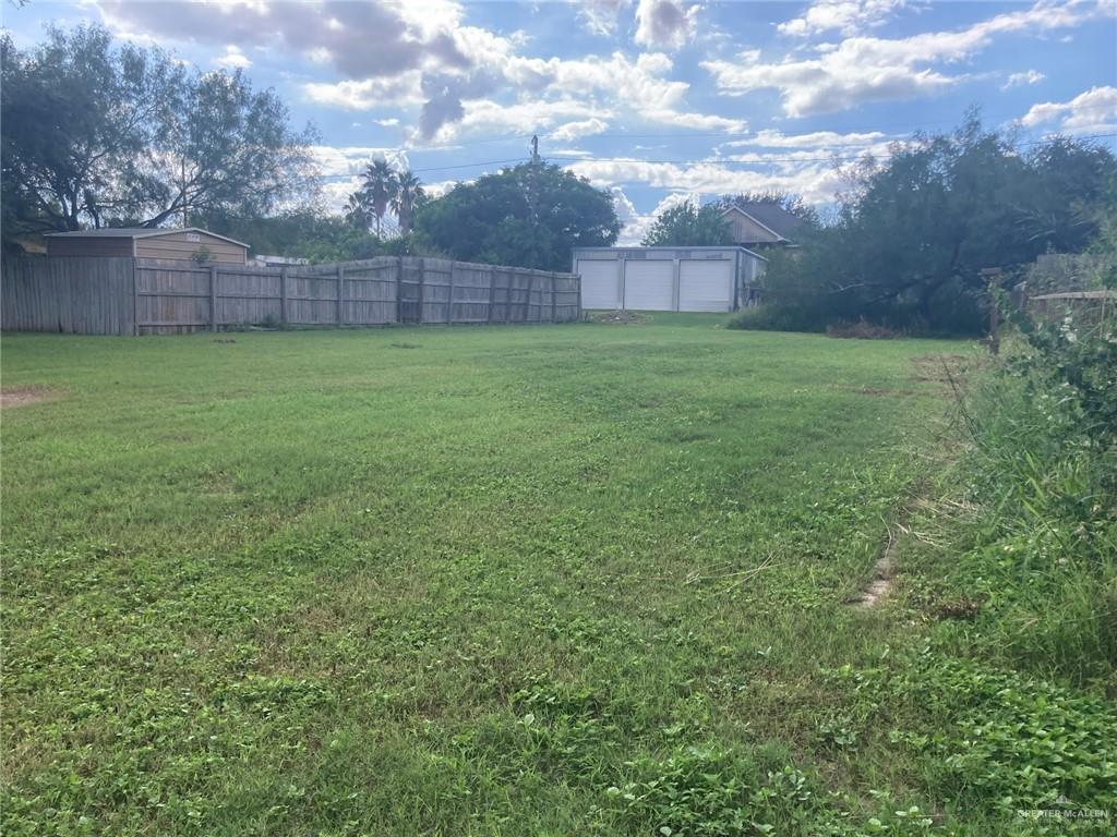 a view of a yard with a bench in a yard