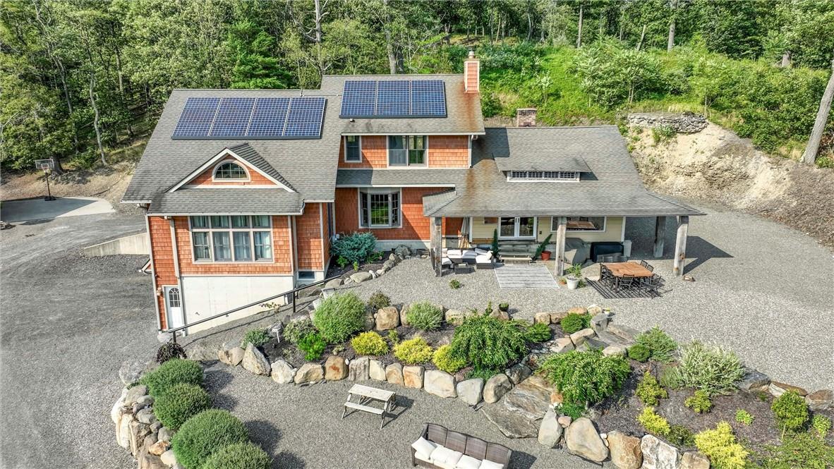 Front view of house with an outdoor living space and solar panels