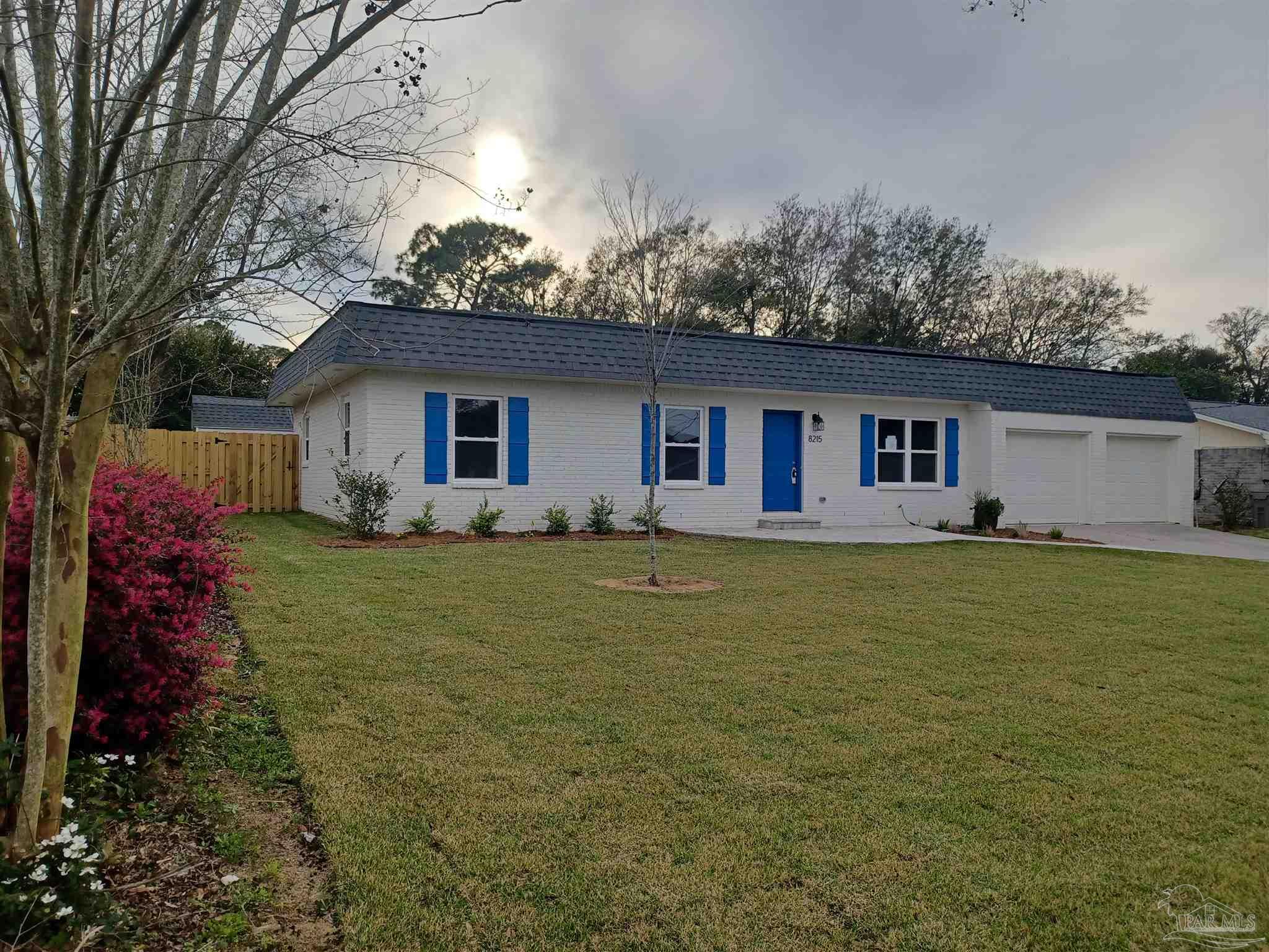 a front view of house with yard and lake view