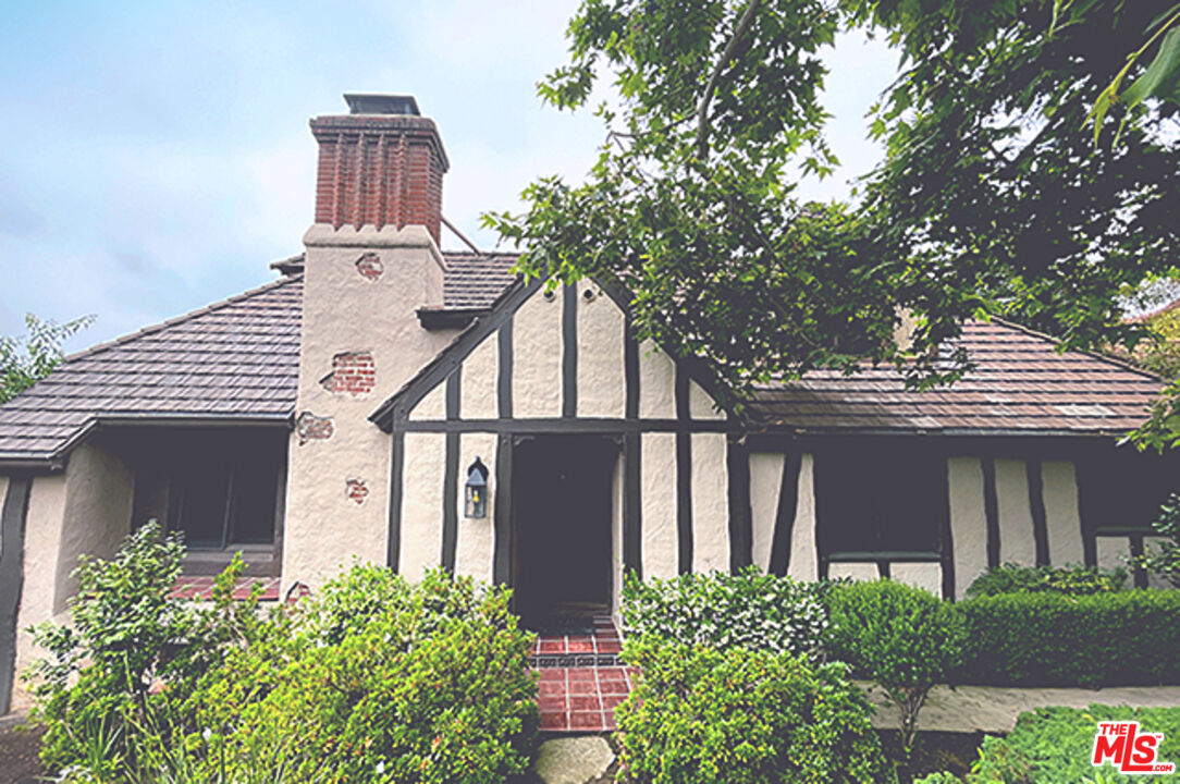 front view of a house with a garden