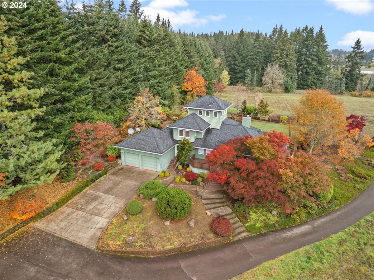 an aerial view of a house with a yard basket ball court and outdoor seating