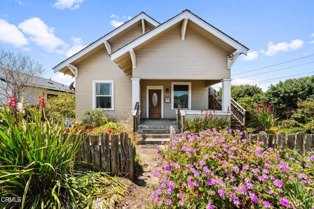 a front view of house with flowers