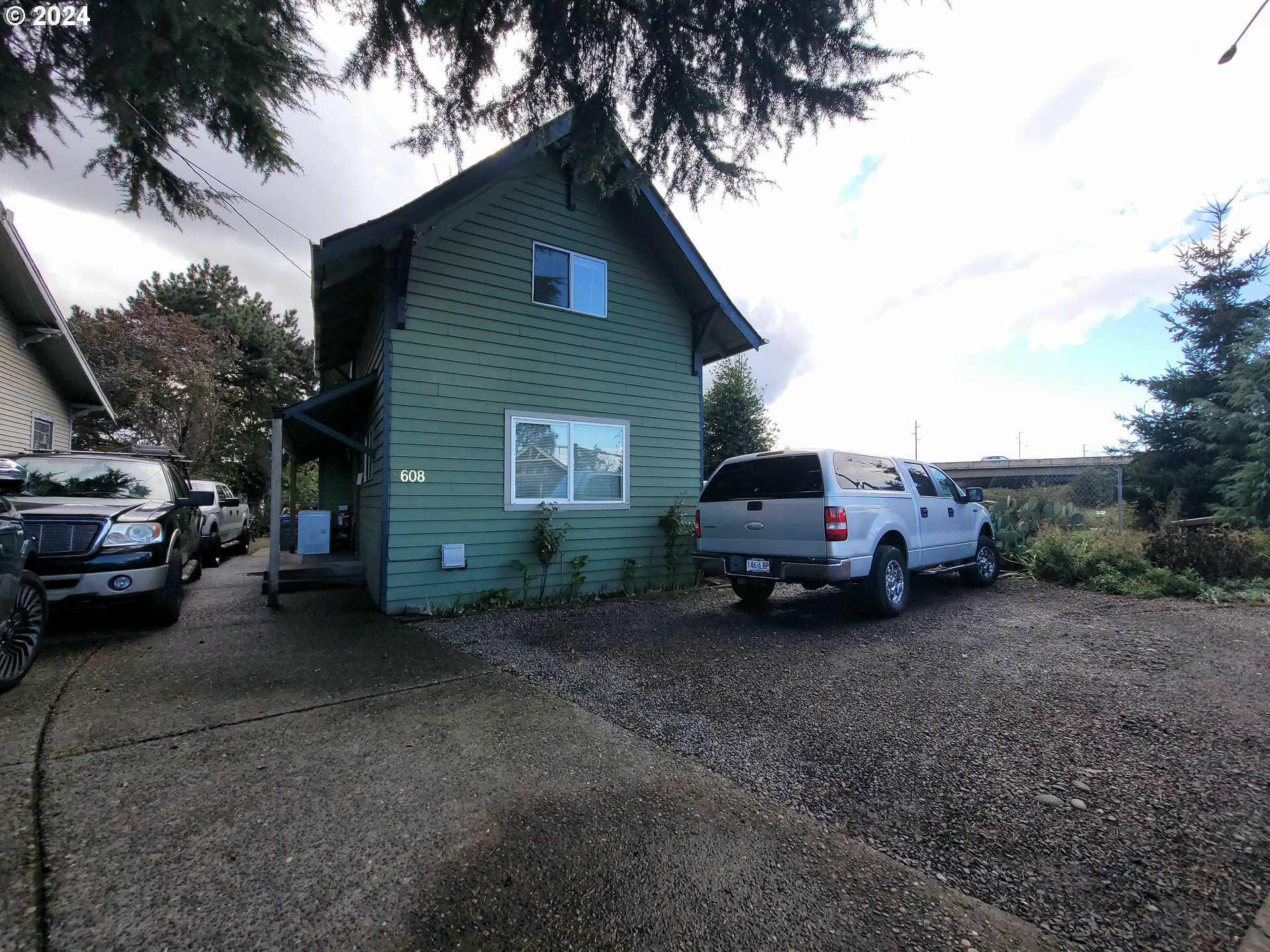 a view of a house with a car parked in garage