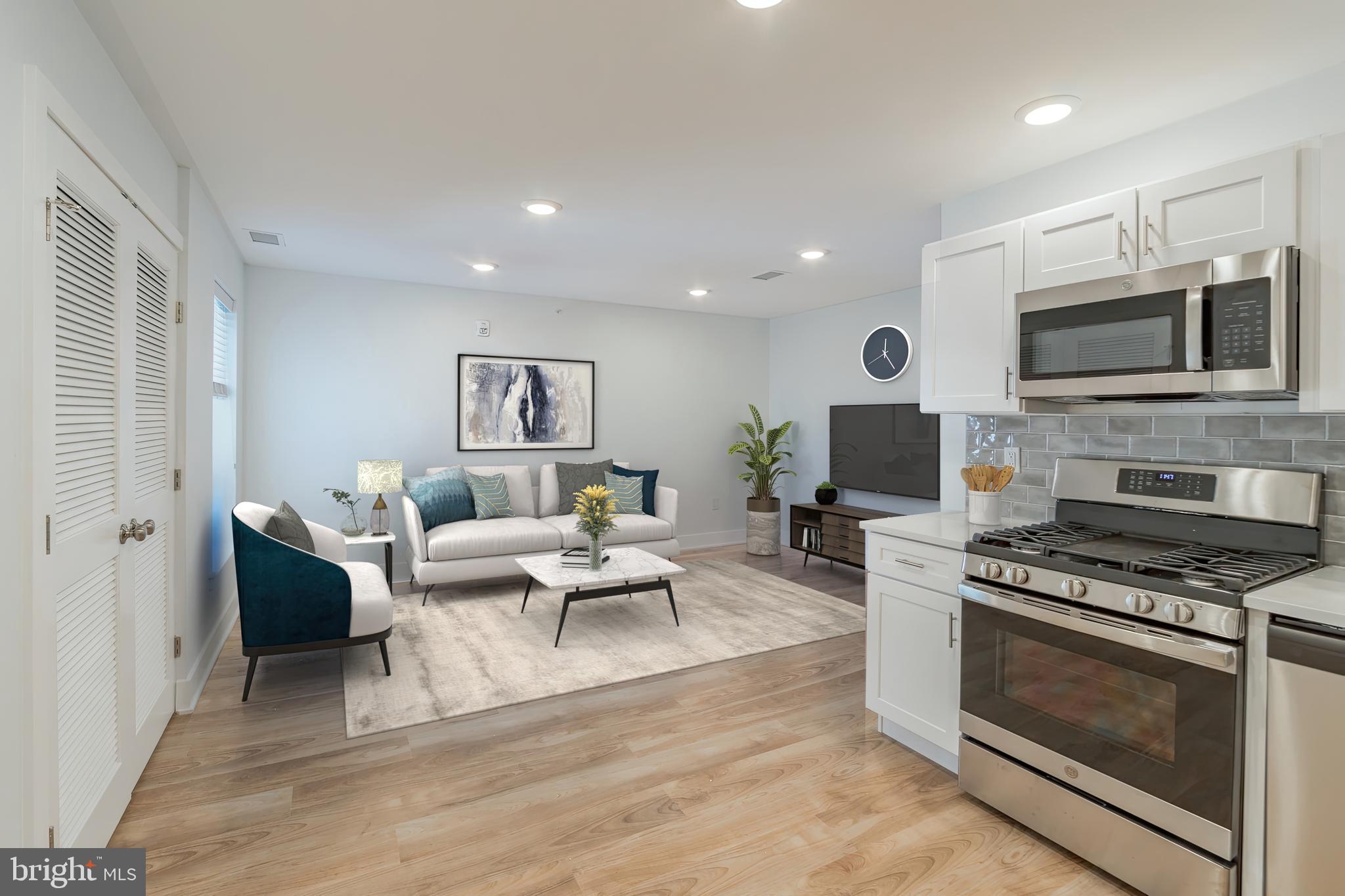 a living room with furniture a flat screen tv and a fireplace