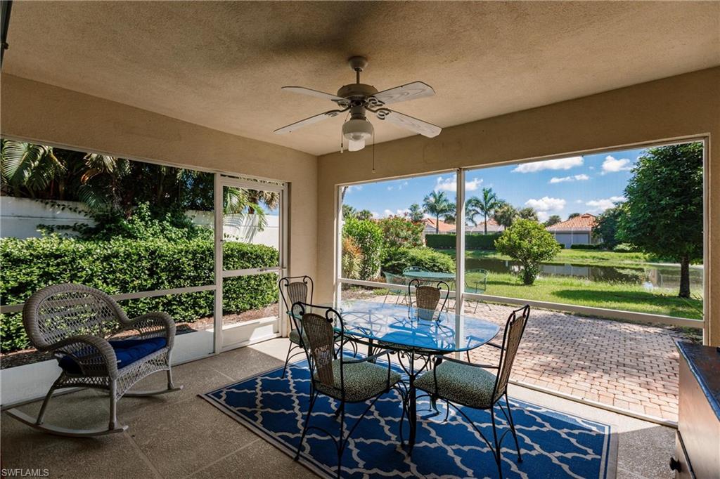 a view of a patio with a table chairs and a backyard