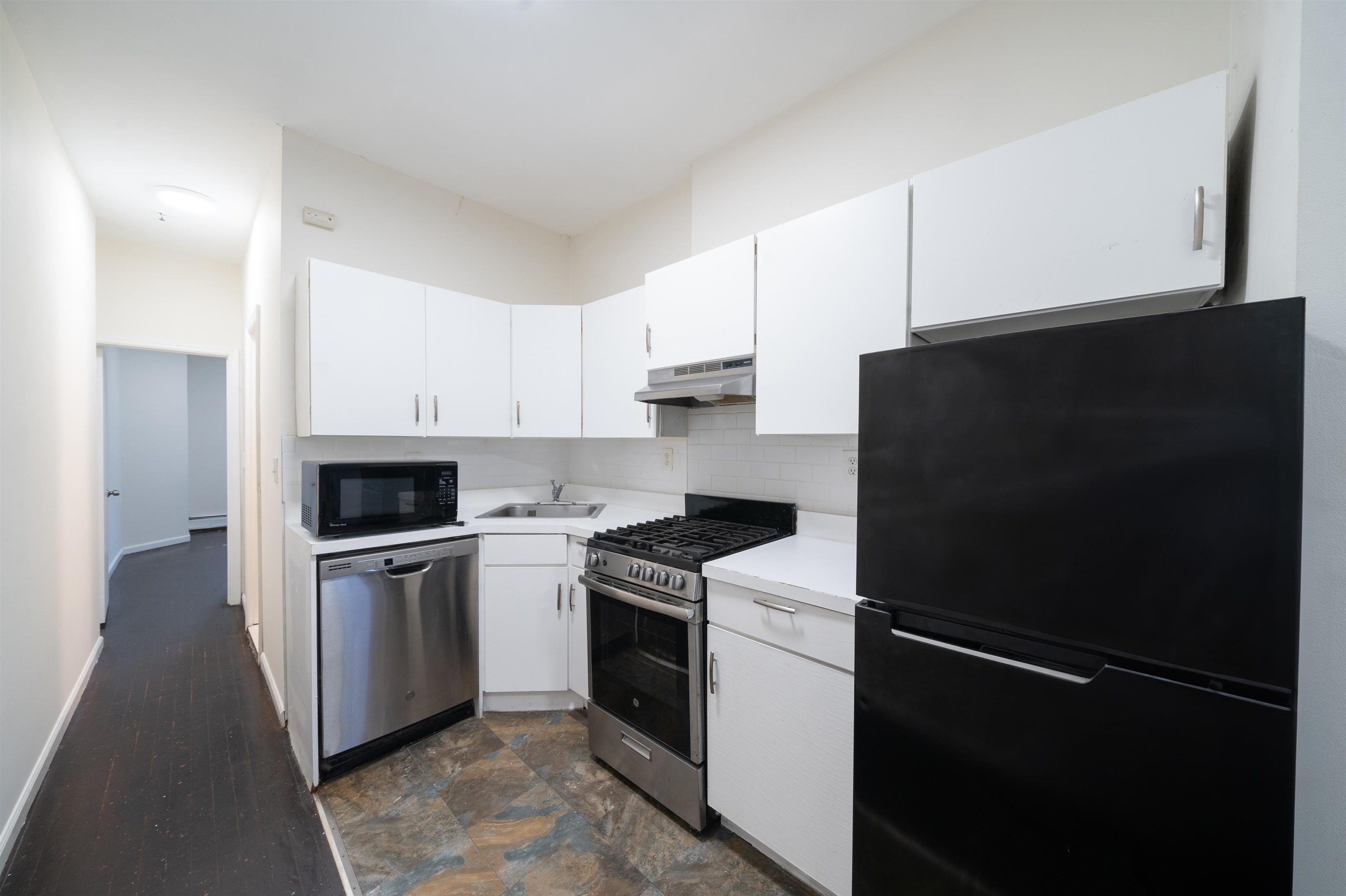 a kitchen with a sink appliances and cabinets