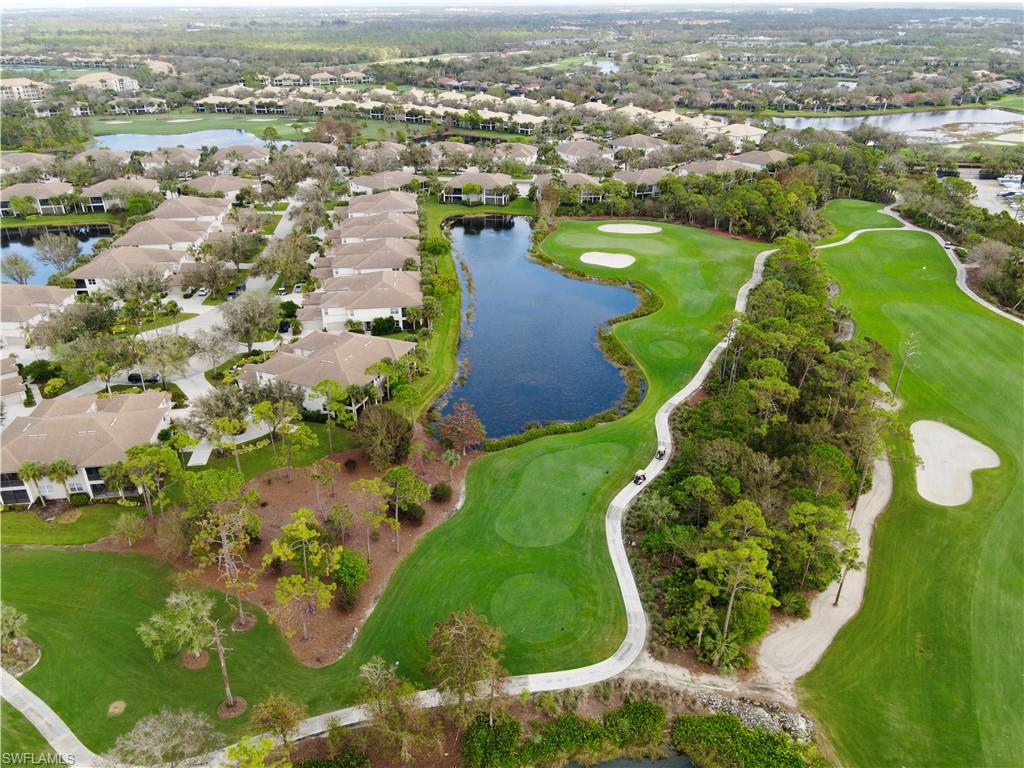 an aerial view of a residential houses with outdoor space and parking