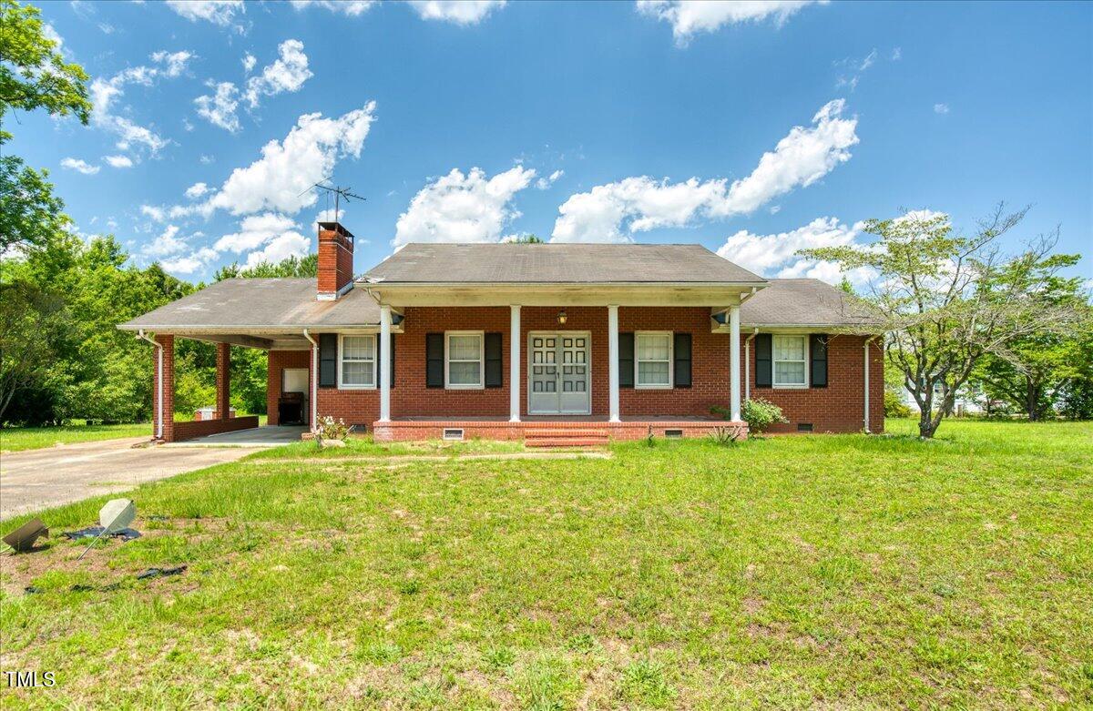 a front view of a house with a yard and porch