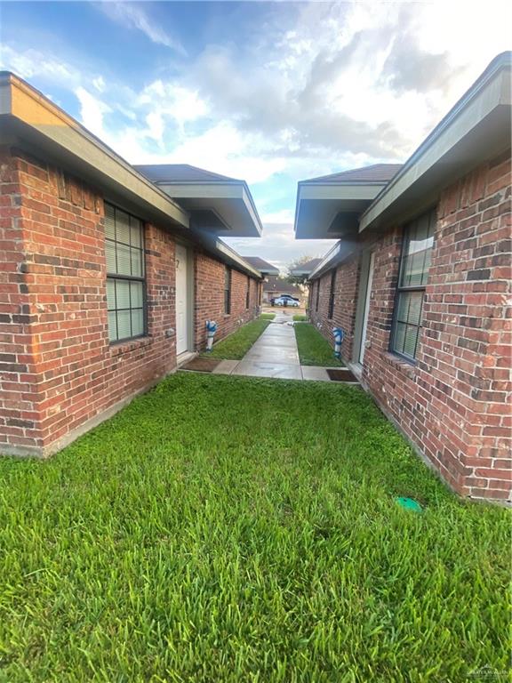 a view of an house with backyard and porch