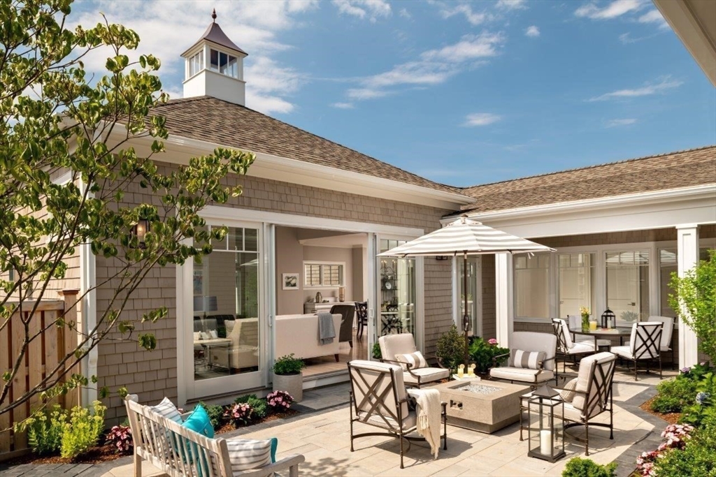 a building outdoor space with patio furniture and potted plants