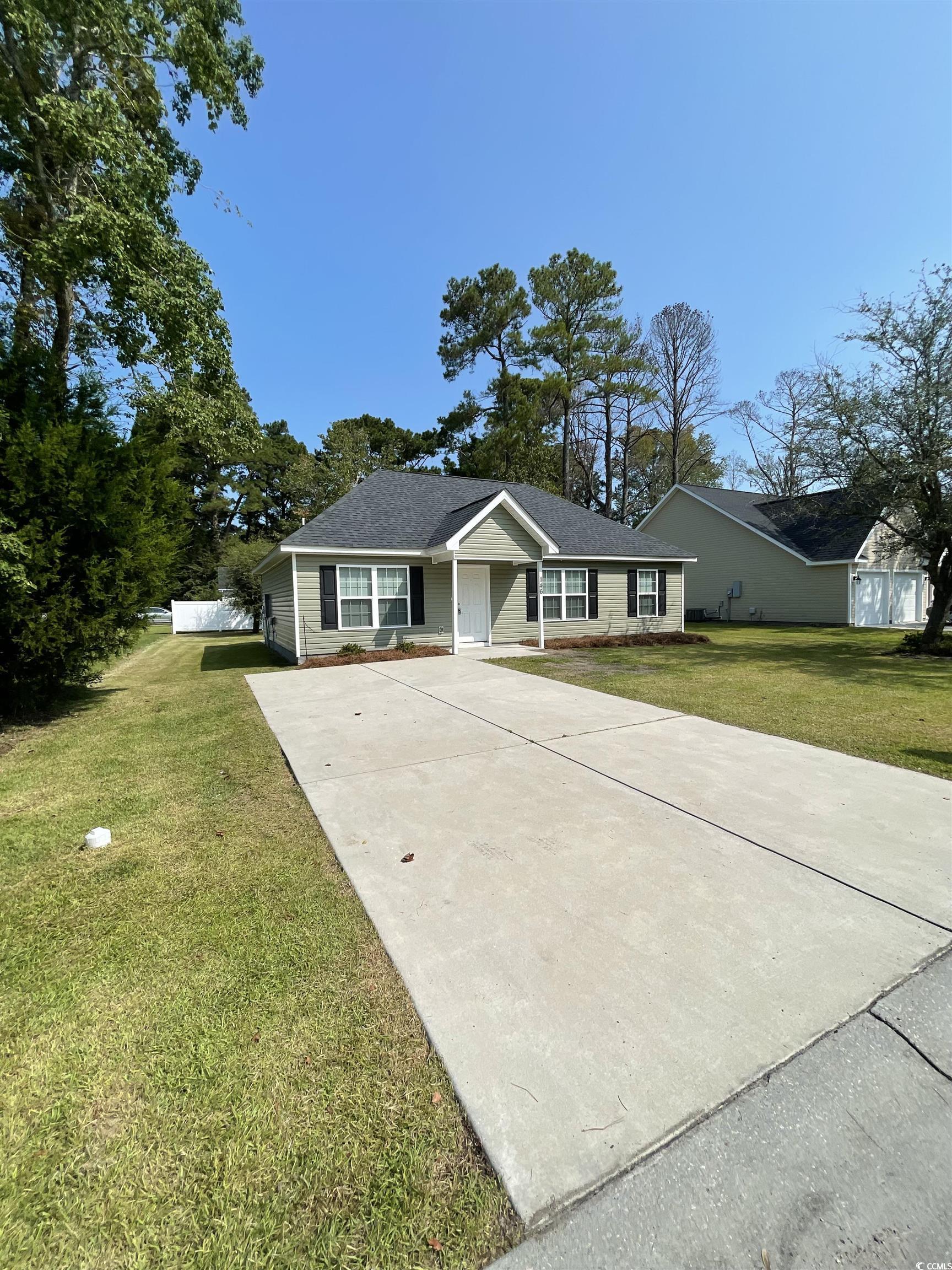 Ranch-style home featuring a front lawn