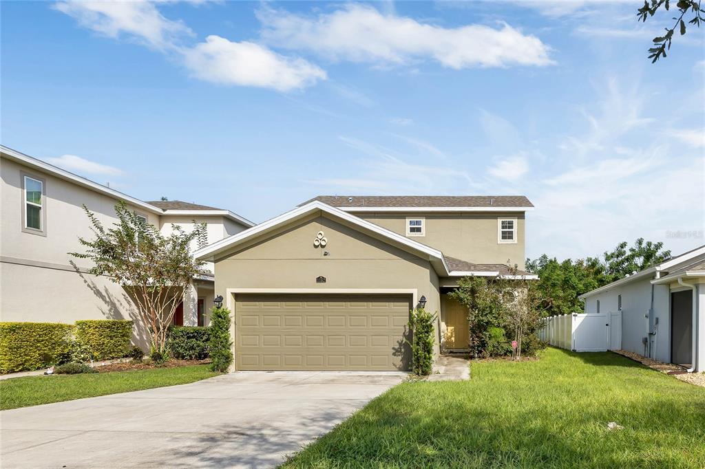 a front view of a house with a yard and garage