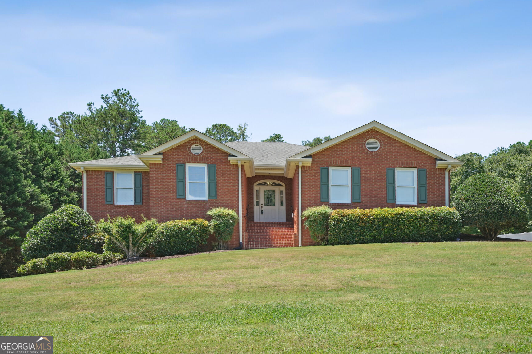 a front view of a house with a yard