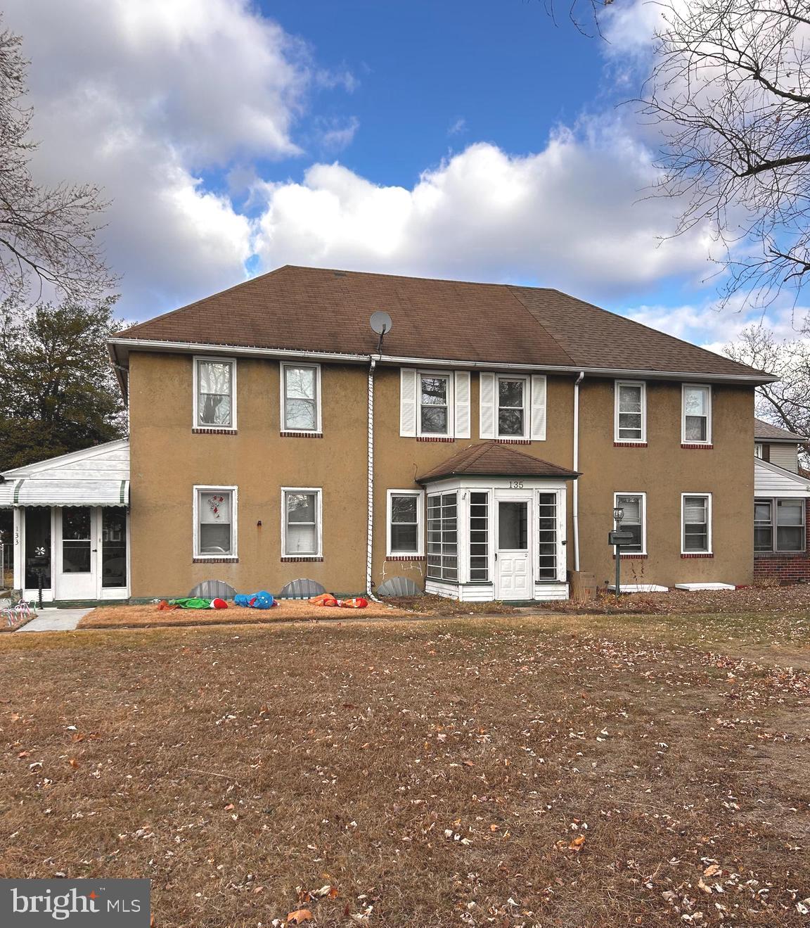 a front view of a house with a garden